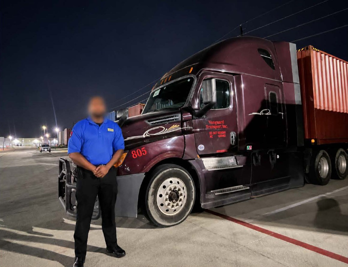 Vanguard driver alongside a truck at night